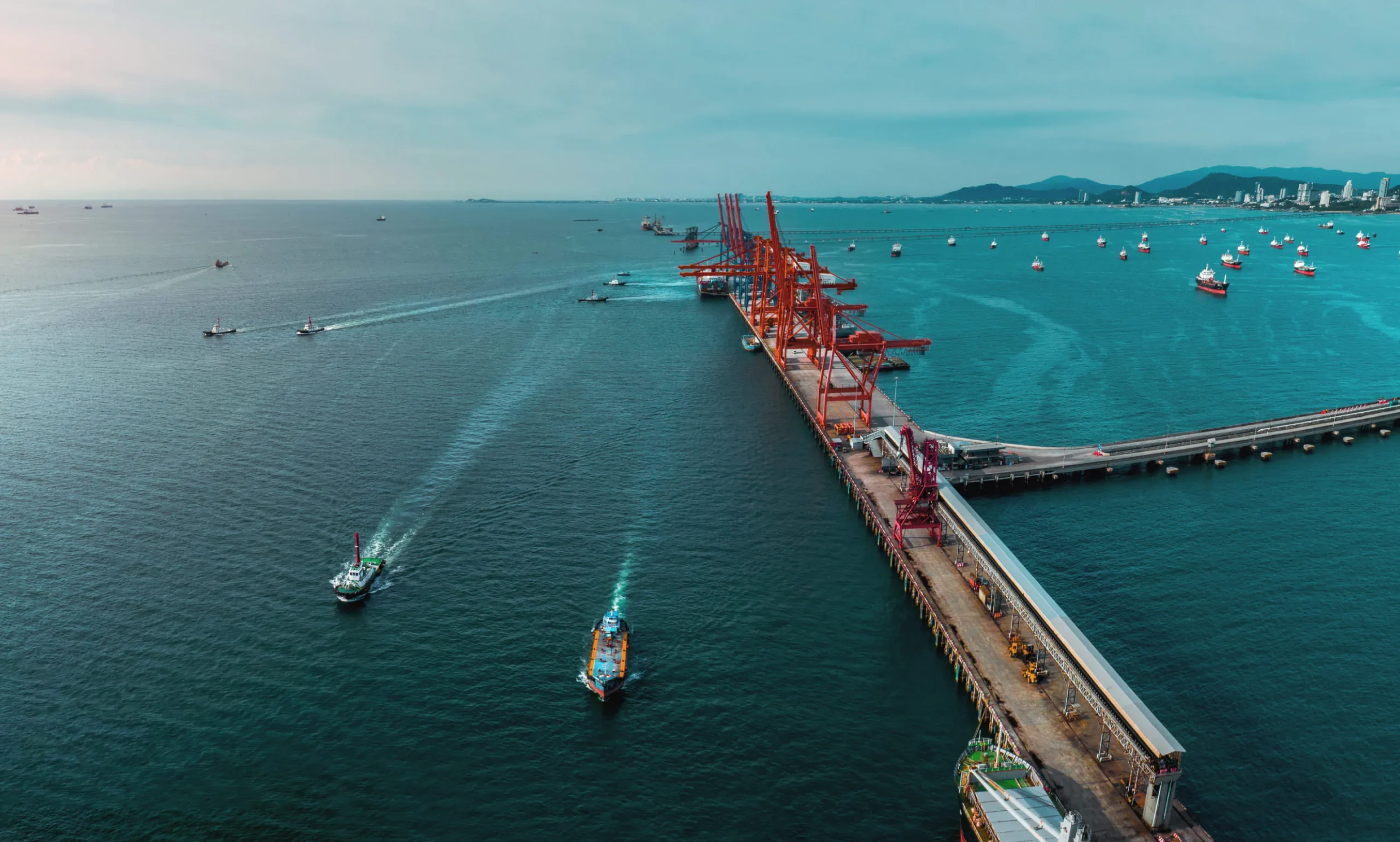 A dockyard seamlessly connected to a road, showcasing the integration of maritime and land transportation for efficient cargo movement